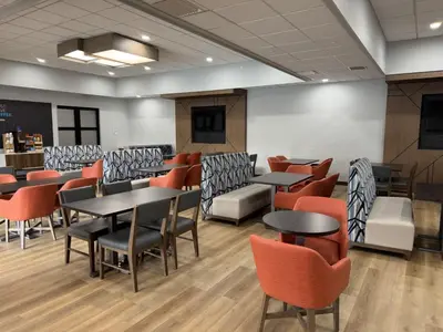 a dining room with tables and chairs at Holiday Inn Express Denver Central - North in Denver