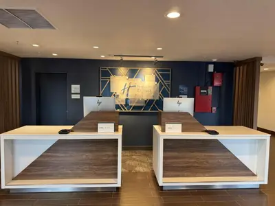 two tables in a room with blue walls at Holiday Inn Express Denver Central - North in Denver