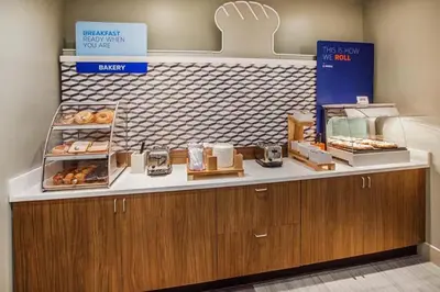 a bakery with a counter with donuts on it at Holiday Inn Express Denver Central - North in Denver