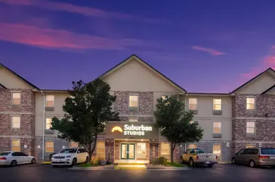 a rendering of a hotel with cars parked in a parking lot at Suburban Studios Denver Central-Arvada in Arvada