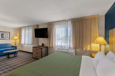 a hotel room with a bed and a television at Quality Inn Denver Northeast Brighton in Brighton