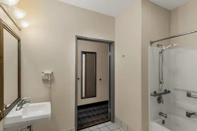 a bathroom with a sink and a shower and a mirror at Quality Inn Denver Northeast Brighton in Brighton