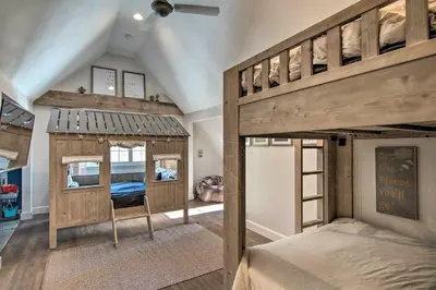 a bedroom with two bunk beds in a room at Outdoor Kitchen and Swim Spa 1-Acre Grand Lake Home in Grand Lake