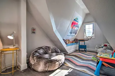 a room with a staircase with a bean bag chair at Outdoor Kitchen and Swim Spa 1-Acre Grand Lake Home in Grand Lake