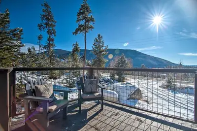 a balcony with two chairs and a view of a mountain at Outdoor Kitchen and Swim Spa 1-Acre Grand Lake Home in Grand Lake