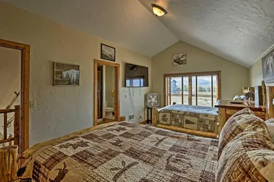 a bedroom with two beds and a window at Golf, Ski and Hike Luxe Group Getaway in Granby! in Granby
