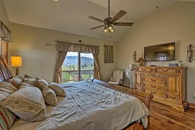 a bedroom with a bed and a dresser and a window at Golf, Ski and Hike Luxe Group Getaway in Granby! in Granby