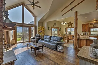 a living room with a couch and a table at Golf, Ski and Hike Luxe Group Getaway in Granby! in Granby