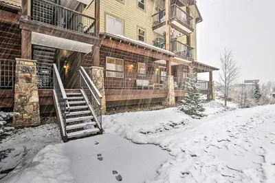 a house in the snow with a snow covered driveway at Four-Season Winter Park Condo with Pool Access! in Winter Park