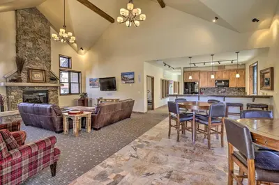 a living room with a couch and a table at Four-Season Winter Park Condo with Pool Access! in Winter Park