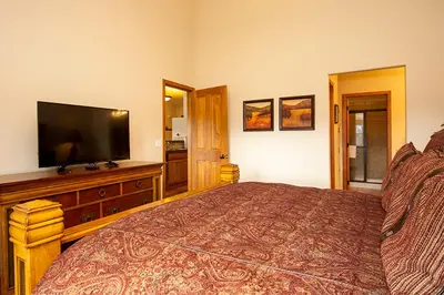 a bedroom with a bed and a flat screen tv at 45 Reunion Court - Rendezvous in Fraser