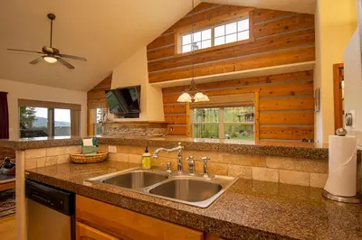 a kitchen with a sink and wooden walls at 45 Reunion Court - Rendezvous in Fraser