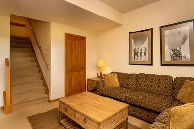 a living room with a couch and a table at 45 Reunion Court - Rendezvous in Fraser
