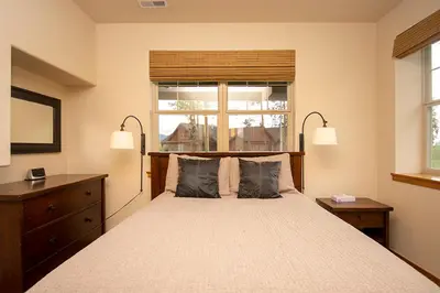 a bedroom with a bed with two pillows and a window at 45 Reunion Court - Rendezvous in Fraser