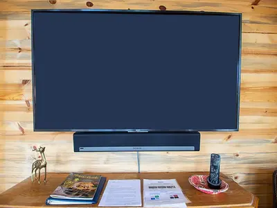 a flat screen tv sitting on top of a table at Miles Behind Log Cabin in Fraser