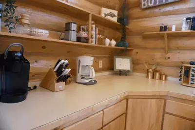 a kitchen with a counter with a coffee maker on it at Miles Behind Log Cabin in Fraser