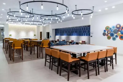 a dining room with a large table and chairs at Hilton Garden Inn Longmont in Longmont