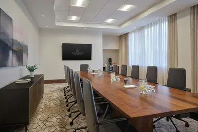 a conference room with a large wooden table and chairs at Sheraton Denver West Hotel in Lakewood