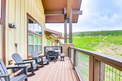 a balcony with chairs and a table with a view at Ski-InandSki-Out Granby Penthouse with Mountain Views! in Granby