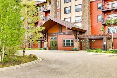 a building with a driveway in front of a building at Ski-InandSki-Out Granby Penthouse with Mountain Views! in Granby