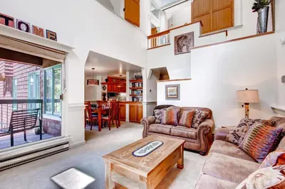 a living room with a couch and a table at Hot Tub and Grilling Area Keystone Townhome! in Keystone