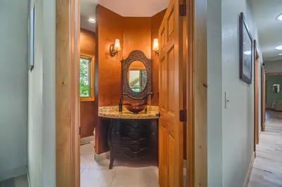 a bathroom with a sink and a mirror at Stunning Mtn Views, Private Stream Evergreen Gem! in Evergreen