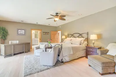 a bedroom with a bed and a living room at Stunning Mtn Views, Private Stream Evergreen Gem! in Evergreen