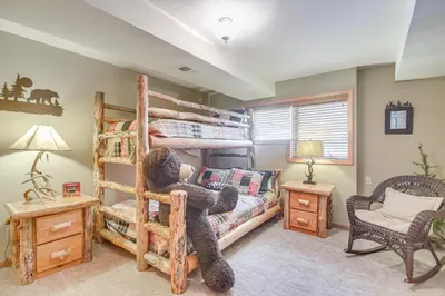a bedroom with a teddy bear sitting on a bunk bed at Stunning Mtn Views, Private Stream Evergreen Gem! in Evergreen