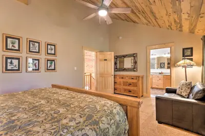 a bedroom with a bed and a ceiling fan at Luxury 4 BR Cabin 2 King Suites on Shuttle Route in Winter Park