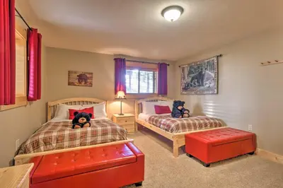 a bedroom with two beds with teddy bears on them at Luxury 4 BR Cabin 2 King Suites on Shuttle Route in Winter Park
