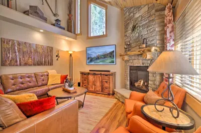 a living room with a couch and a fireplace at Luxury 4 BR Cabin 2 King Suites on Shuttle Route in Winter Park