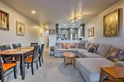 a living room with a couch and a table at Walk to Main Street Frisco Townhome with Decks in Frisco