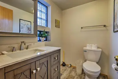 a bathroom with a toilet and a sink and a window at Walk to Main Street Frisco Townhome with Decks in Frisco
