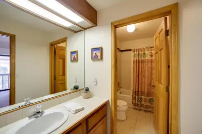 a bathroom with a sink and a toilet and a mirror at 1 Mi to Main Street Mtn-View Home in Frisco in Frisco