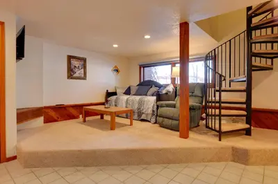 a living room with a bed and a stair case at 1 Mi to Main Street Mtn-View Home in Frisco in Frisco