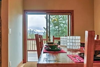 a dining room table with a view of a mountain at Fraser Townhome with Mtn Views - 6 Mi to Winter Park in Fraser