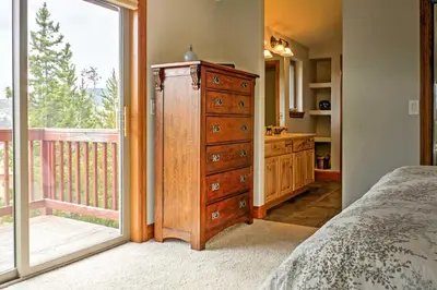 a bedroom with a dresser and a large window at Fraser Townhome with Mtn Views - 6 Mi to Winter Park in Fraser