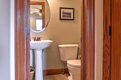 a bathroom with a sink and a toilet and a mirror at Fraser Townhome with Mtn Views - 6 Mi to Winter Park in Fraser