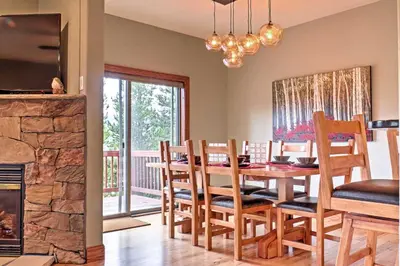 a dining room with a table and chairs and a fireplace at Fraser Townhome with Mtn Views - 6 Mi to Winter Park in Fraser