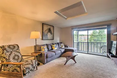 a living room with a couch and a balcony at Winter Park Condo on Bus Route, 2 Blocks to Dtwn! in Winter Park