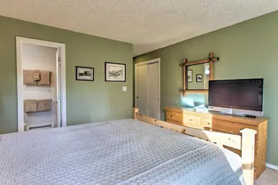 a bedroom with a bed and a flat screen tv at Winter Park Condo on Bus Route, 2 Blocks to Dtwn! in Winter Park