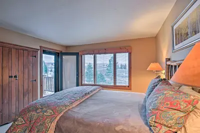 a bedroom with a bed and a large window at 2 Mi to Skiing Mtn-View Home with Deck in Granby! in Granby