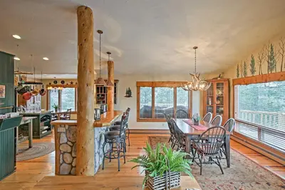 a kitchen and dining room with a table and chairs at 2 Mi to Skiing Mtn-View Home with Deck in Granby! in Granby
