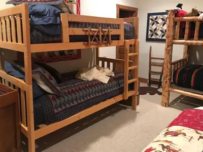 a room with two bunk beds and a bed at 2 Mi to Skiing Mtn-View Home with Deck in Granby! in Granby
