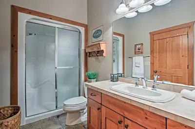 a bathroom with a toilet and a sink and a shower at 2 Mi to Skiing Mtn-View Home with Deck in Granby! in Granby