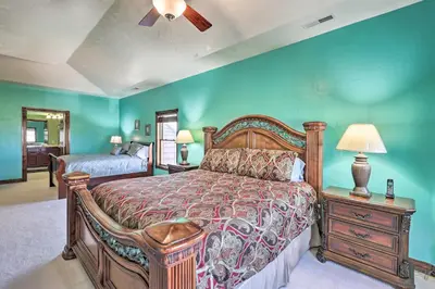 a bedroom with a bed and a night stand with a lamp at 10 Mi to Barr Lake State Park Home with Mtn Views in Hudson