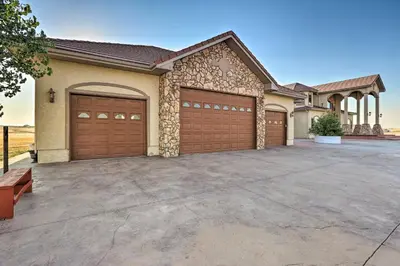 a house with two garage doors in a driveway at 10 Mi to Barr Lake State Park Home with Mtn Views in Hudson