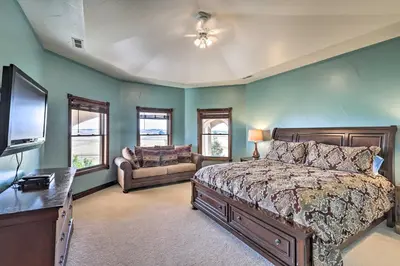 a bedroom with a bed and a couch and a television at 10 Mi to Barr Lake State Park Home with Mtn Views in Hudson