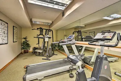 a gym with several exercise bikes and a treadmill at Englewood Apt with Patio in Denver Tech Center in Englewood
