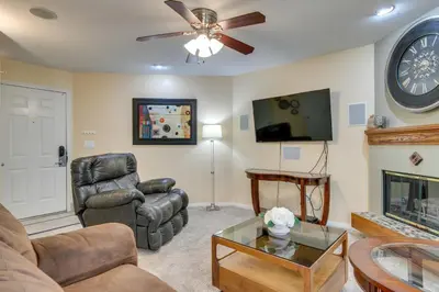 a living room with a couch and a fireplace at Englewood Apt with Patio in Denver Tech Center in Englewood